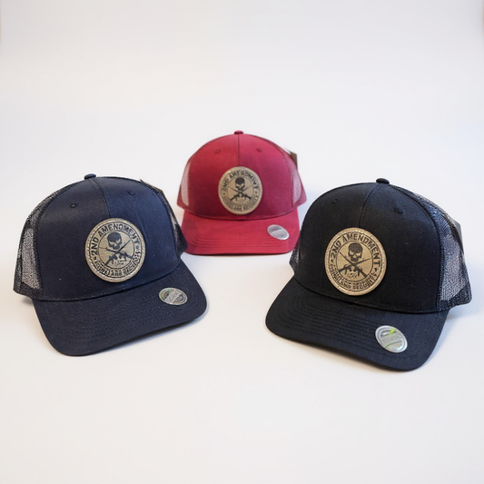 Three baseball caps with skull and crossbones designs on a white background